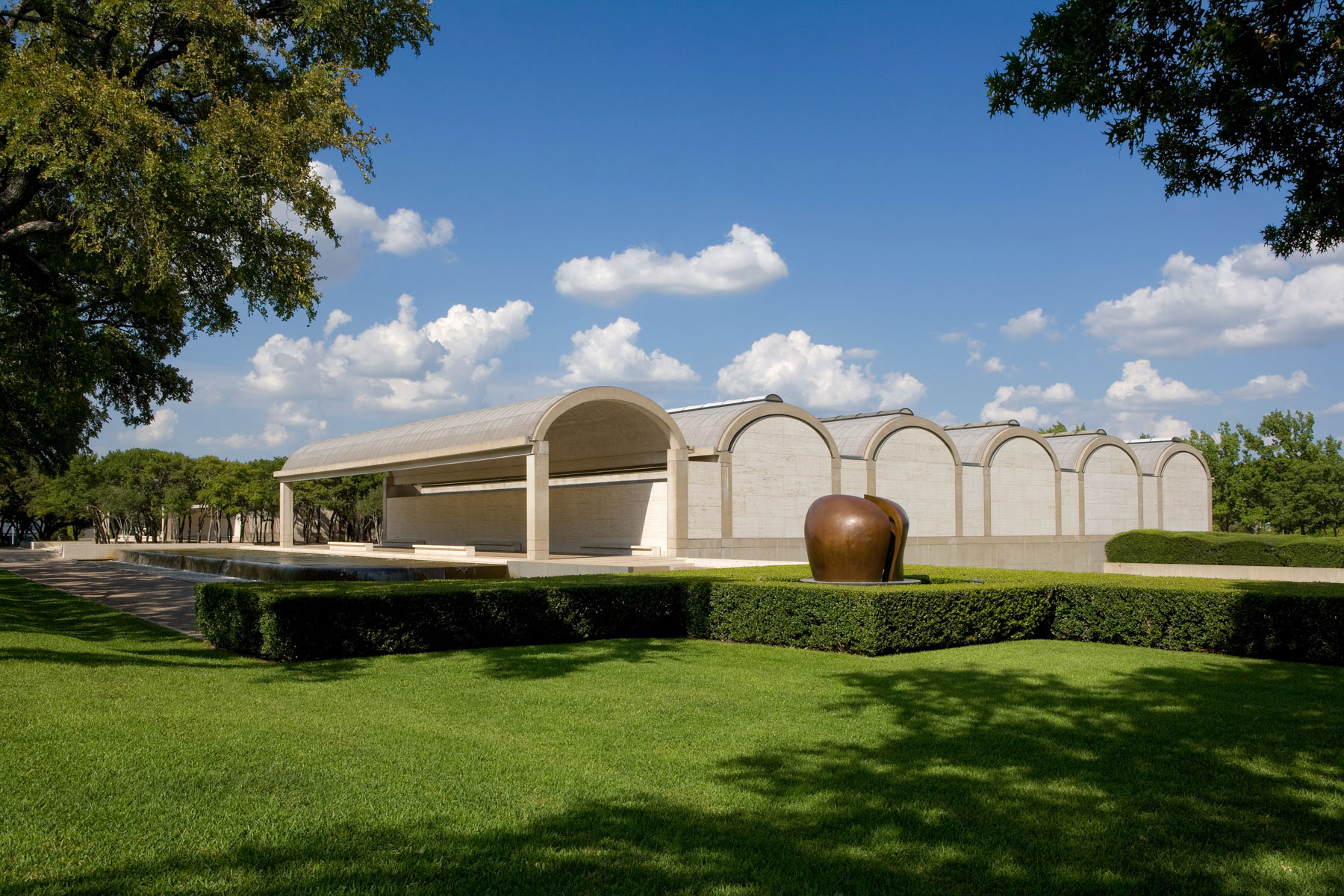 The Kimbell Art Museum façade with a sculpture in the foreground.