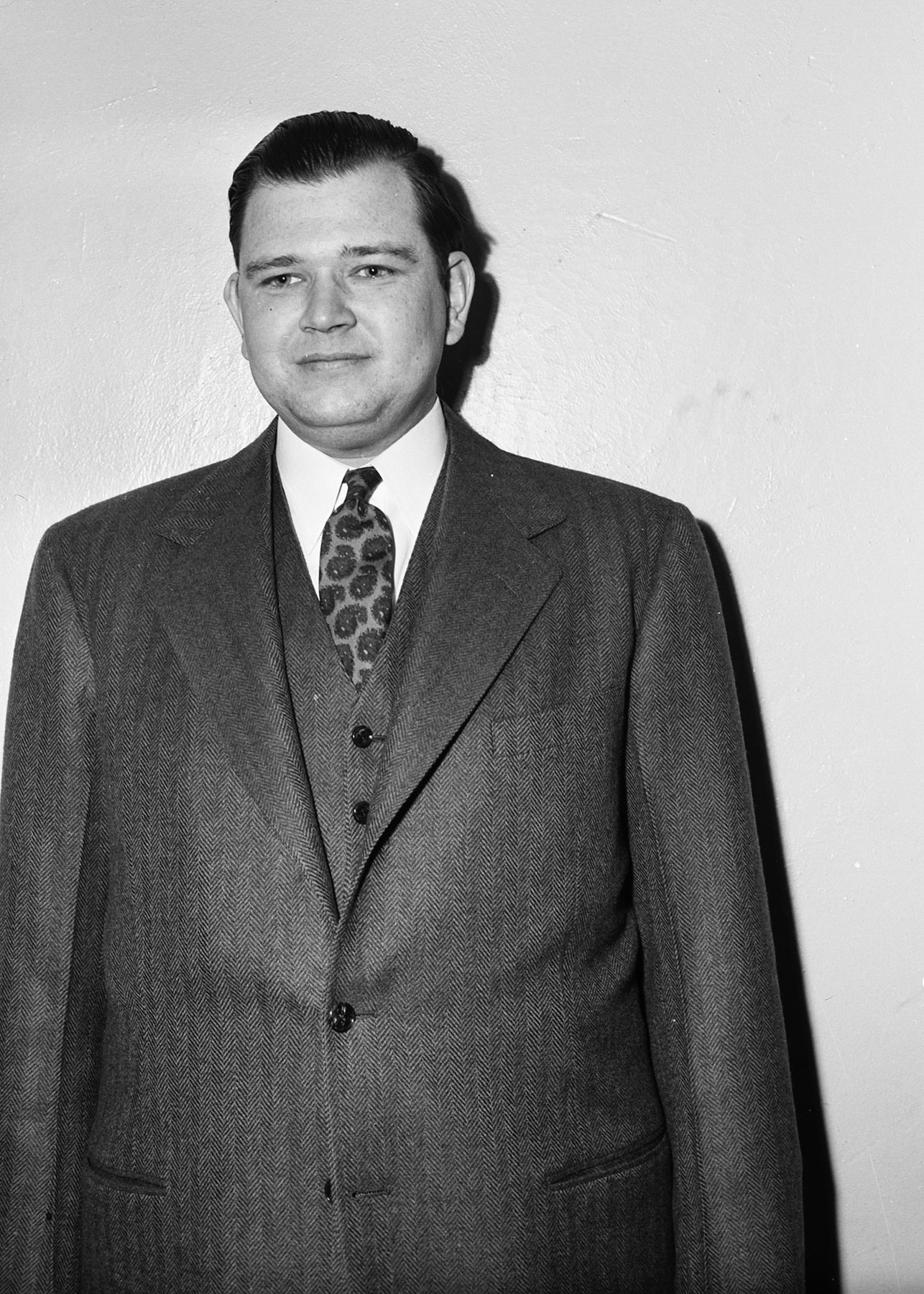Black-and-white photo of a man in a three-piece suit.