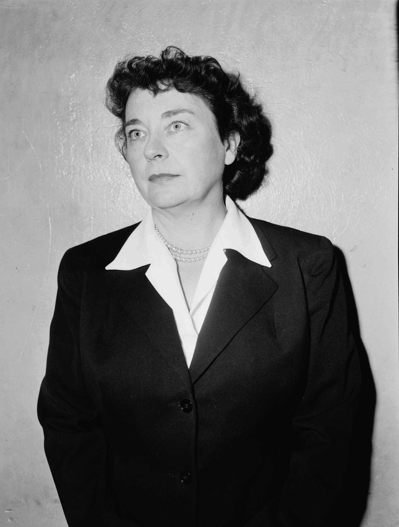 Black-and-white photo of a woman wearing a suit.